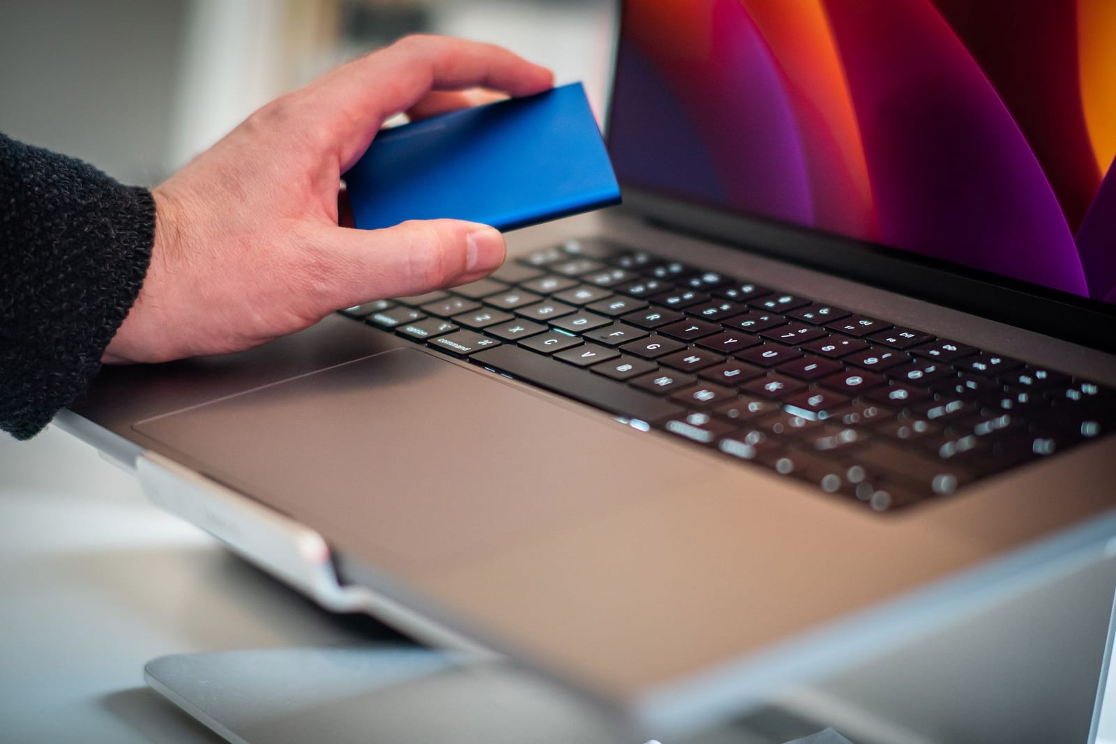 An external storage drive beside a laptop