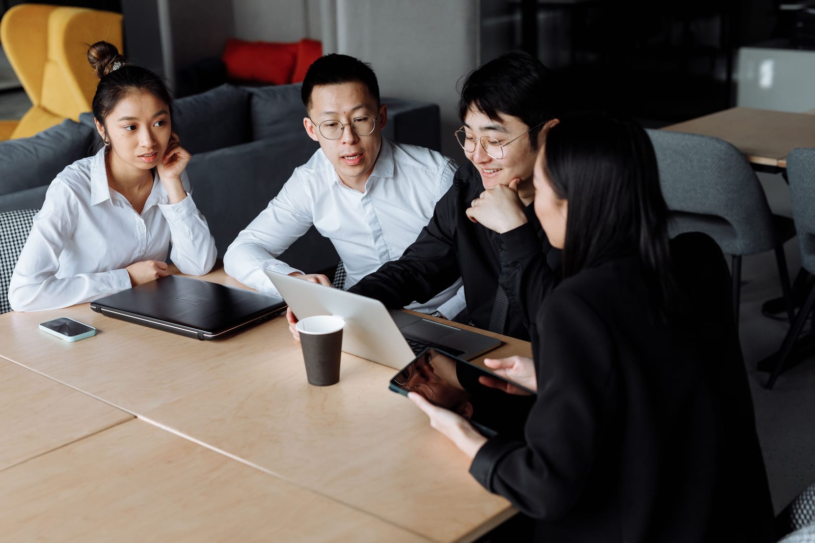 A team discussing technology work around a meeting table