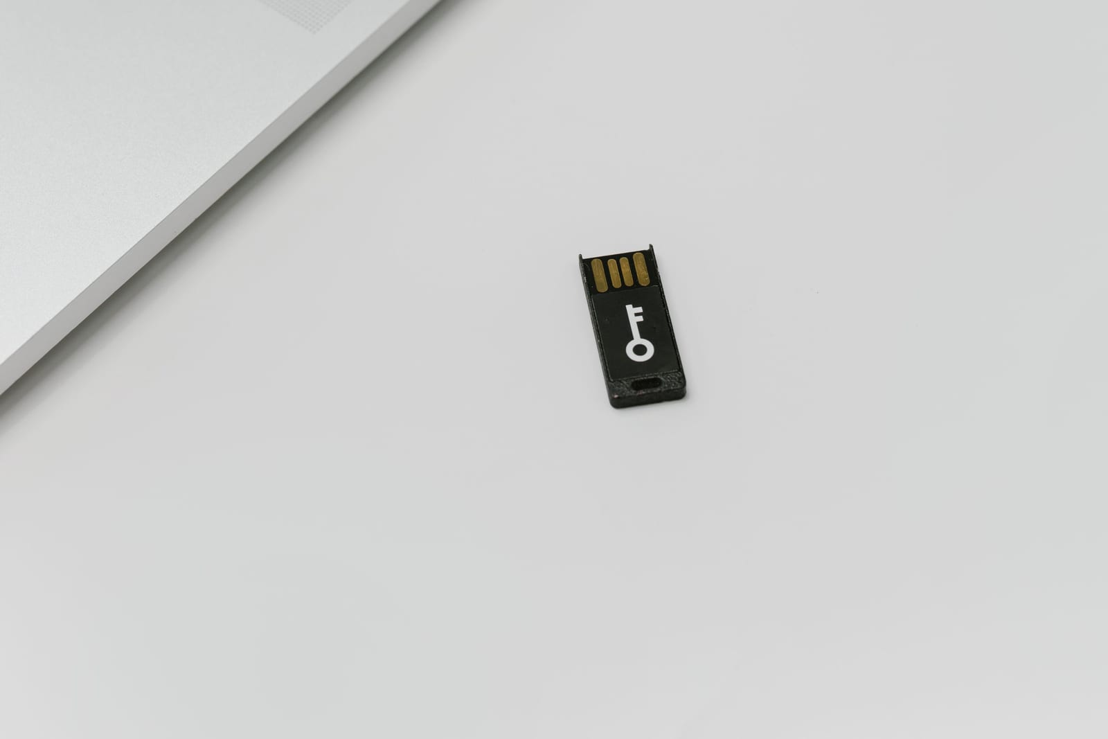 Hardware security key beside a laptop