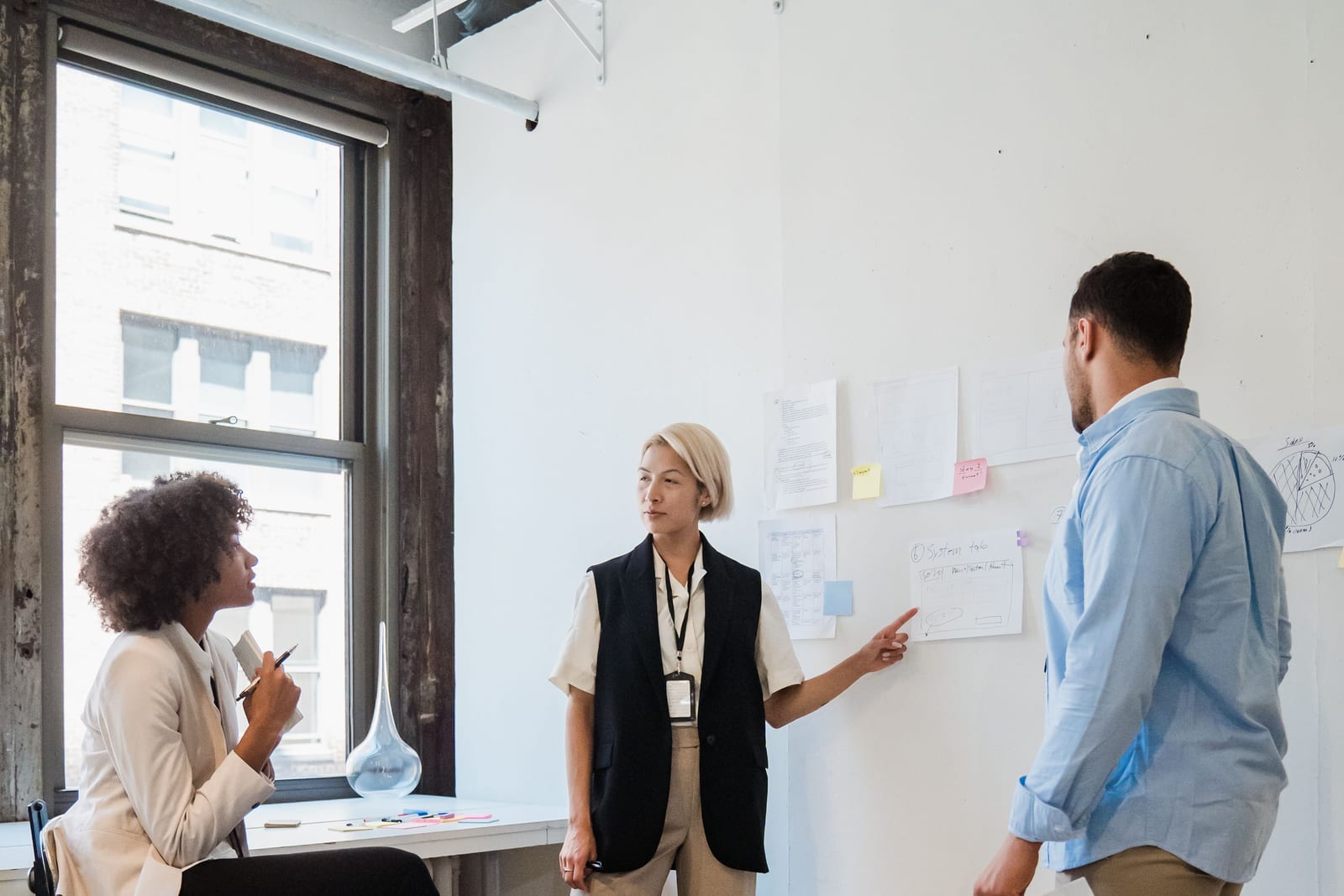 Professionals discussing a project plan at a desk